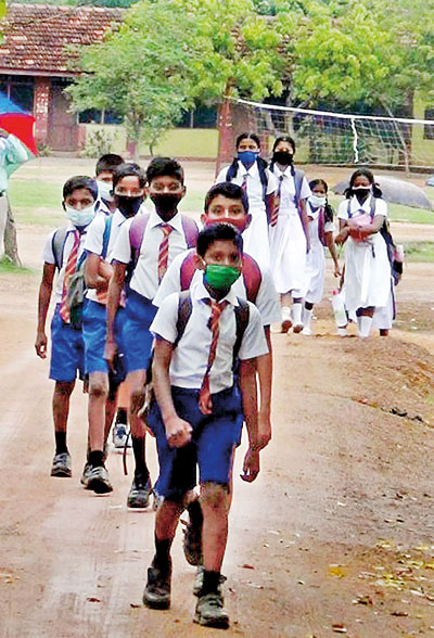 Students of Puttalam Hindu Central College walking to school in uniform